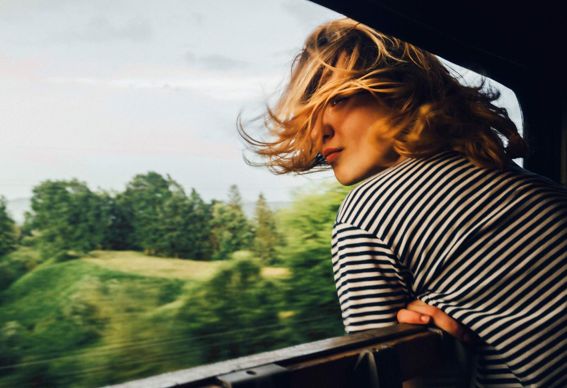 Caucasian woman looking at the view from train window