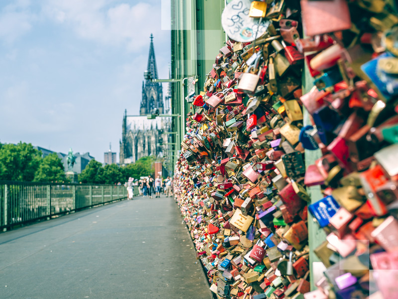 Padlocks on the Hohenzollern Bridge in Cologne, with the cathedral in the background.
