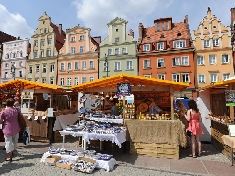Market stalls in Salt Square, Plac Solny, including traditional pottery, honey and flowers.