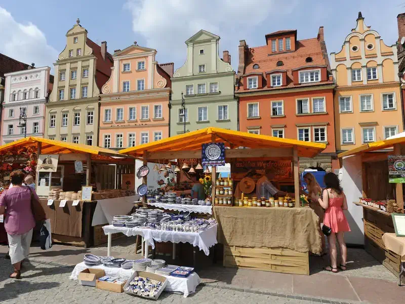 Market stalls in Salt Square, Plac Solny, including traditional pottery, honey and flowers.